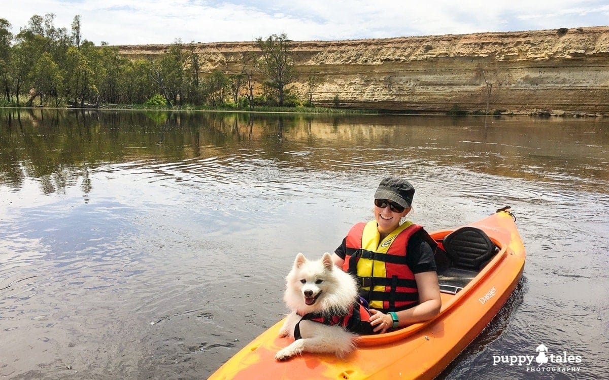 Kerry Martin and her dog Keiko canoeing whilst on a houseboat holiday along the Murray River in Victoria Australia