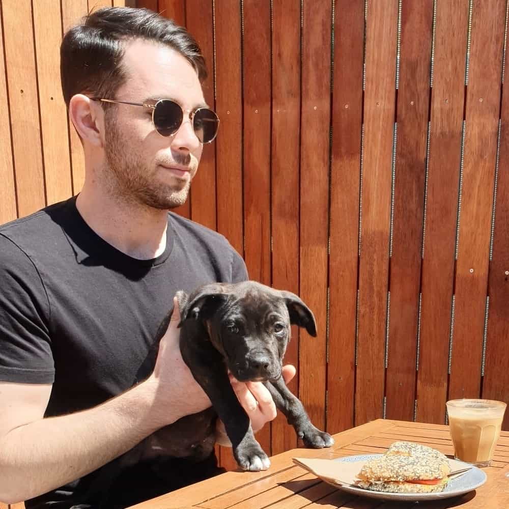 Man and dogsitting outside a pet friendly cafe in Melbourne