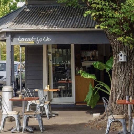 A scenic alfresco dining area at a dog-friendly brunch spot in Melbourne, complete with comfortable seating and picturesque view of the surrounding greenery