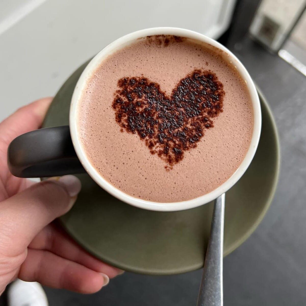Beautiful coffee art that captures the vibrancy of dog-friendly cafes in Melbourne. It features a heart shape, crafted with love and skill from creamy espresso and fluffy milk foam.