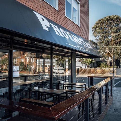 A serene outdoor view of a dog-friendly restaurant in Melbourne, with empty chairs and tables waiting for guests to enjoy a meal.