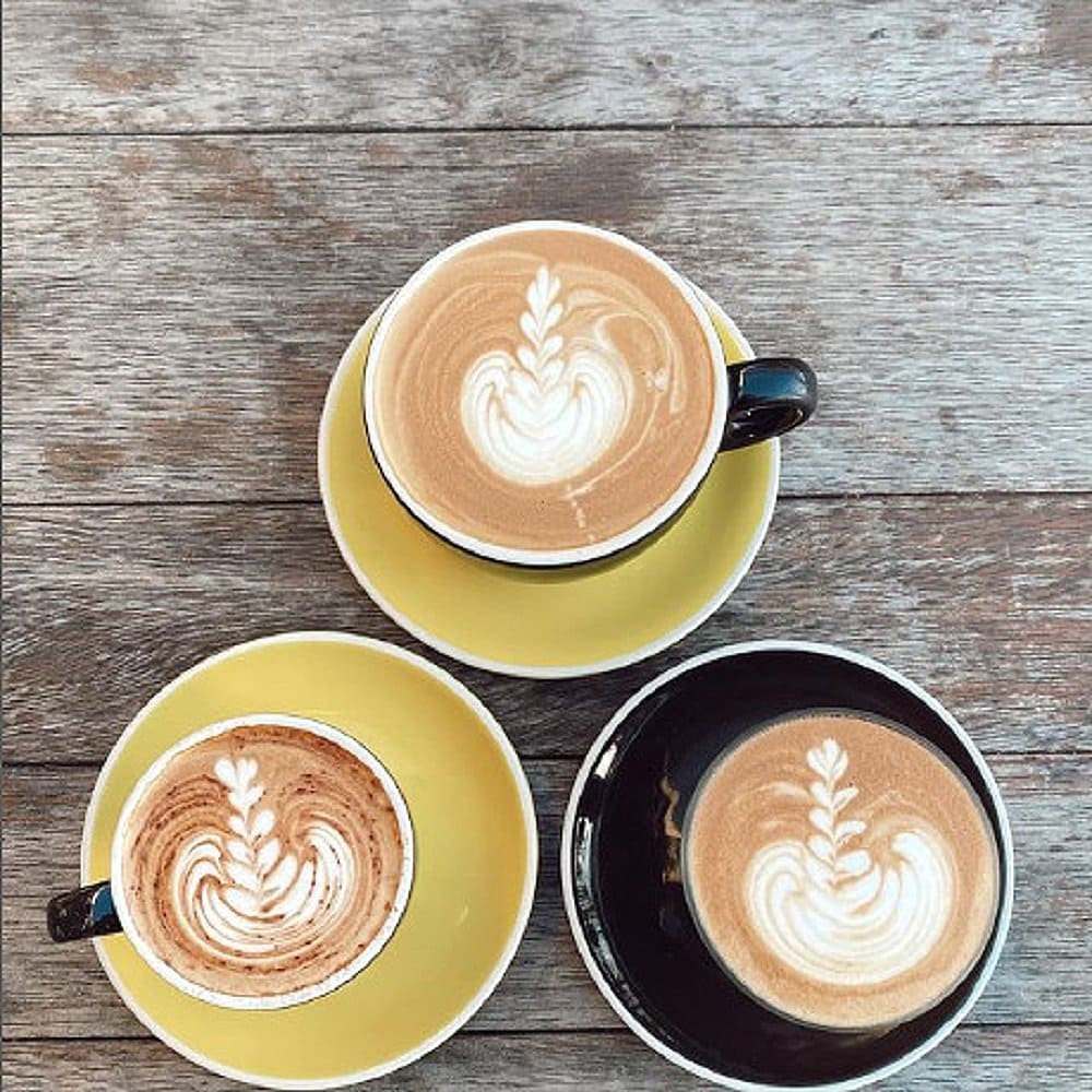 Three beautiful cup of coffee art from a dog friendly cafe in Canberra