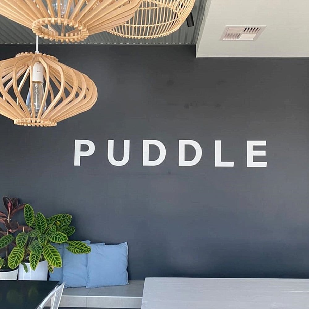 Puddle Cafe in Canberra's showing off their interior and logo in this photo