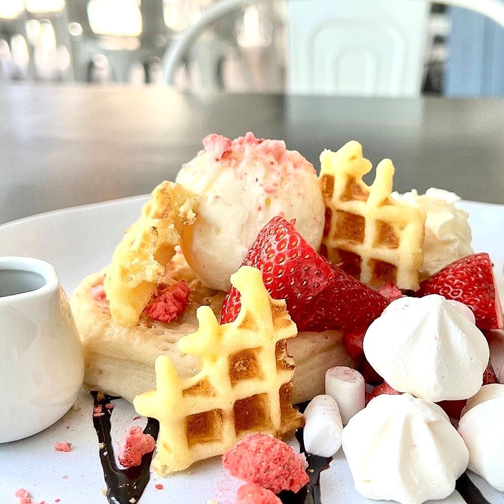Waffles with ice cream and strawberry served in a dog friendly cafe in Canberra