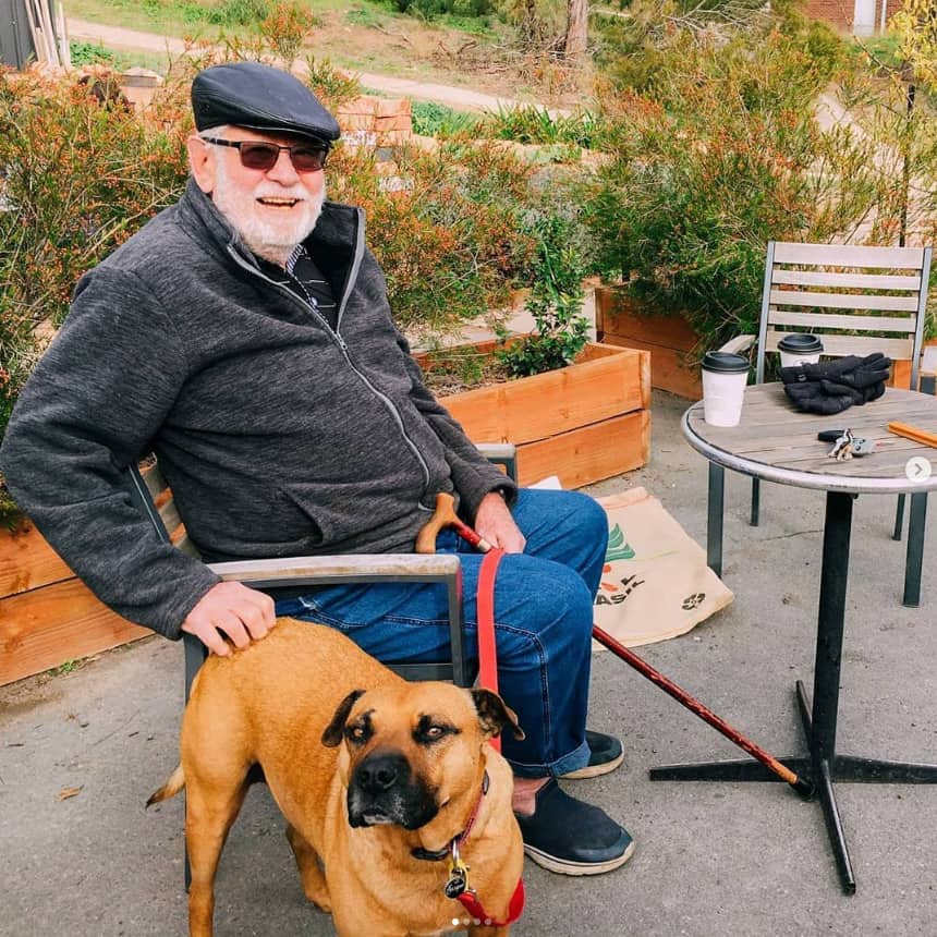 a man and his dog are sitting and having a cup of coffee at Two Before Ten in Canberra