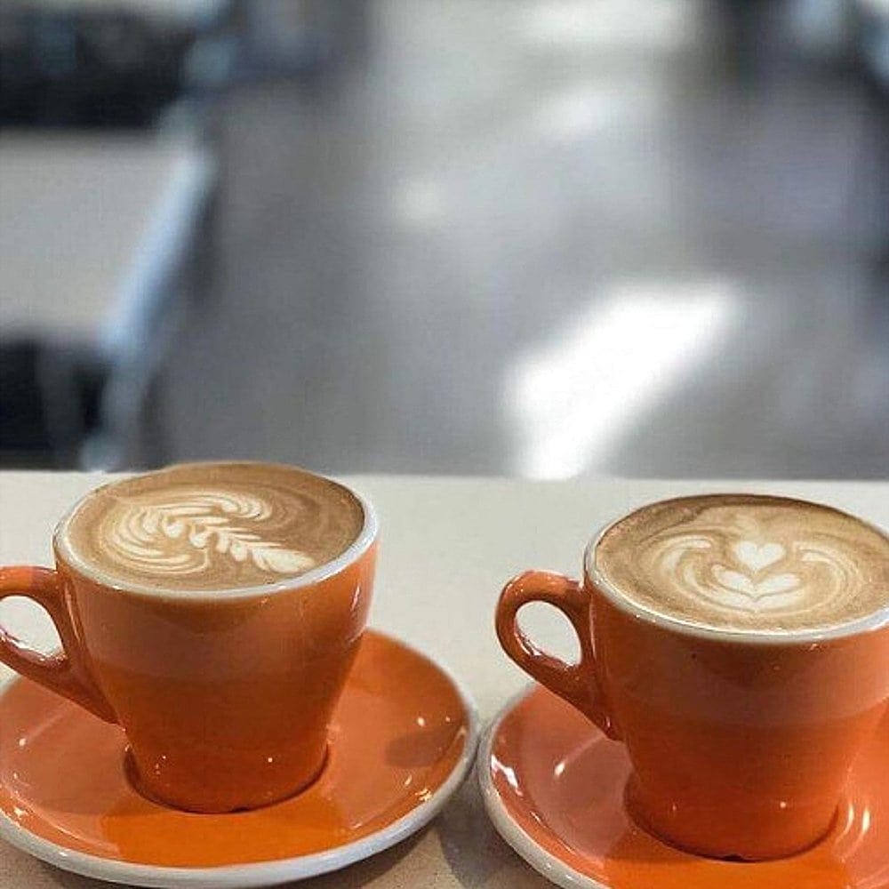 Two cups of coffee on countertop of a dog friendly place in Canberra